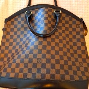 Louis Vutton tote with round handles.